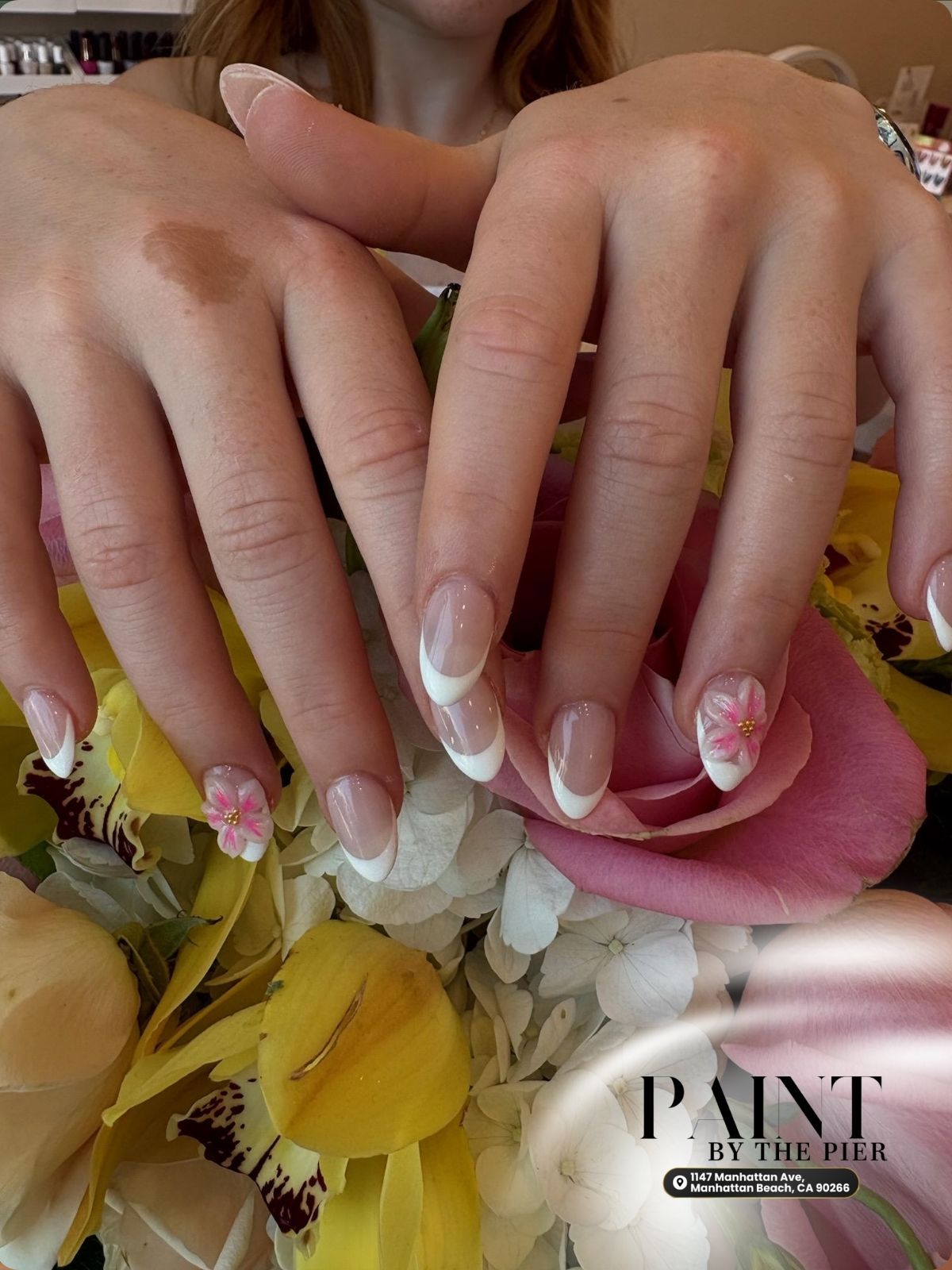 Classic square white french tip manicure with subtle flower detail